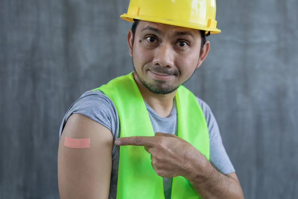 Construction worker with a bandaid from a flu shot