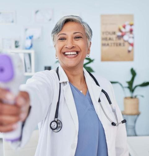 happy-mature-woman-doctor-and-infrared-thermomete-2023-11-27-04-57-54-utc Happy mature woman, doctor and infrared thermometer in checking temperature or fever at hospital. S.